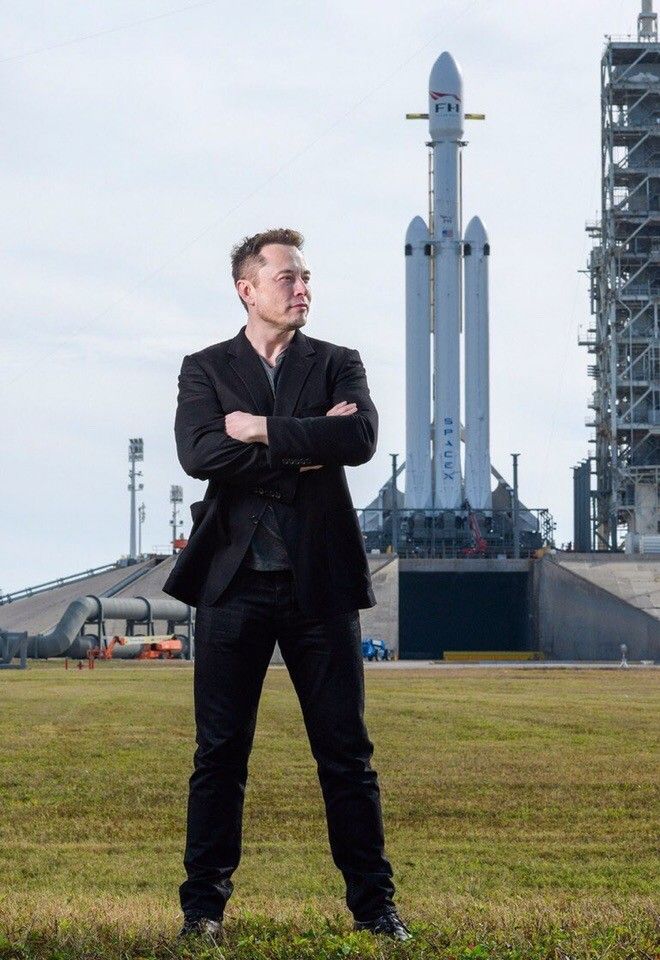 Elon Musk standing in front of a SpaceX spacecraft, symbolizing interplanetary exploration