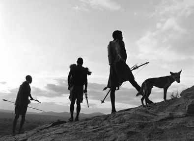 Hadzabe men tracking wildlife during a hunting expedition