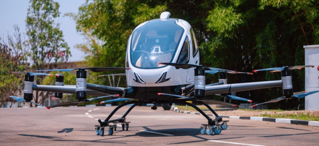 Drone aviator operating a drone controller in an outdoor setting, monitoring flight for aerial survey or delivery operations.