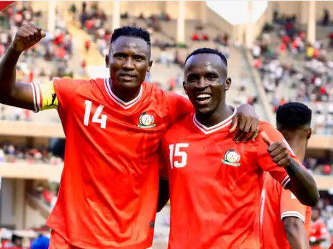 Ryan Ogam (right) celebrating with Harambee Stars teammates on the pitch after an international match