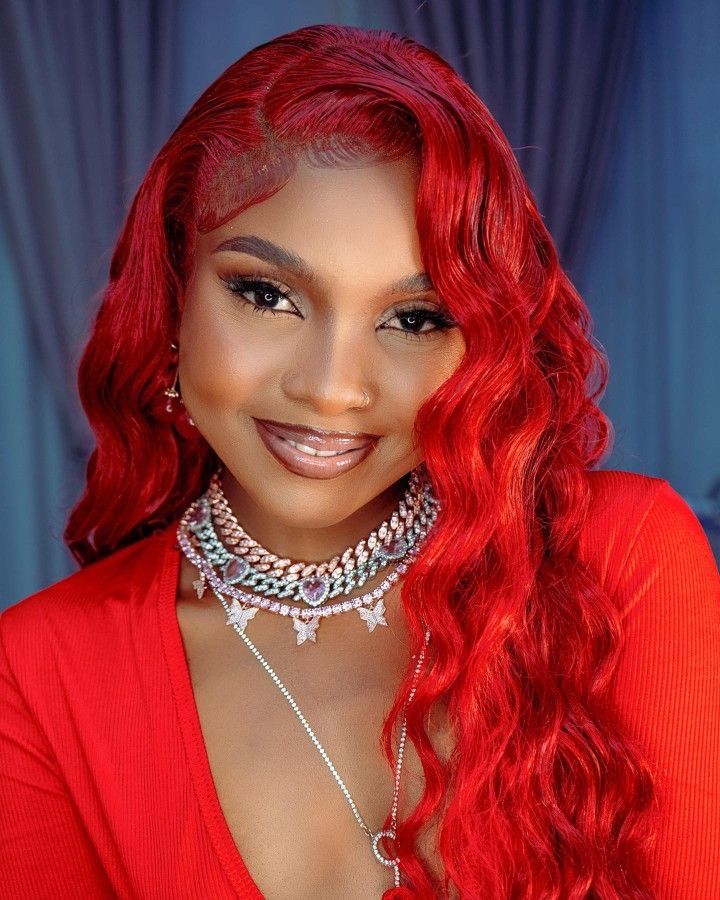 Zuchu, Tanzanian singer, wearing a stylish blue outfit, posing confidently with a bright smile.”