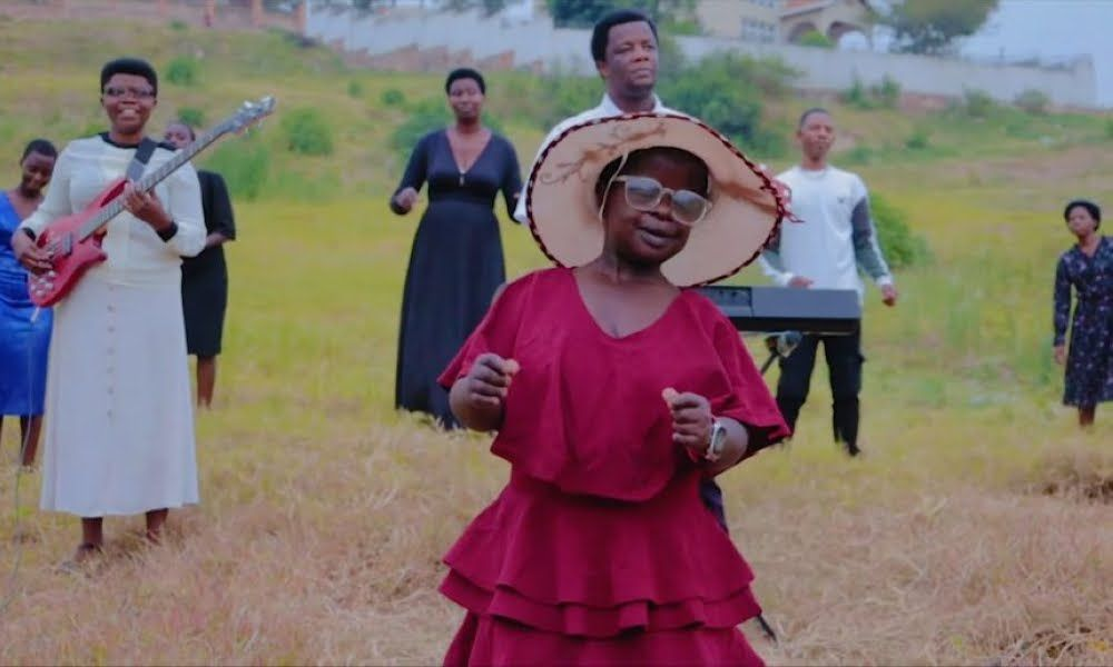 Gogo Gloriose’s burial ceremony in Rwanda with a choir singing gospel songs beside her casket