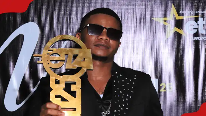 Tanzanian artist Mondi G proudly holding his ETA Awards 2025 trophy after winning the Talent to Watch category.