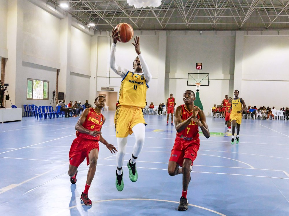 Young basketball player attempting a layup while two defenders close in