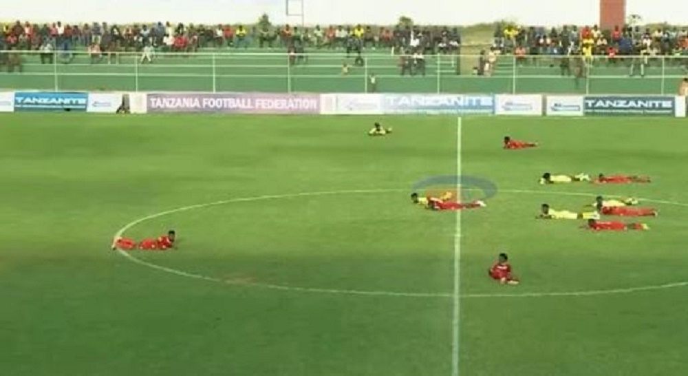 Football players lying on the ground at Kwaraa Stadium to avoid being stung by a swarm of bees during the match.