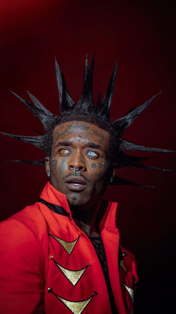 Lil Uzi Vert performing on stage with dark, rebellious aesthetics that symbolize pushing boundaries in the music world